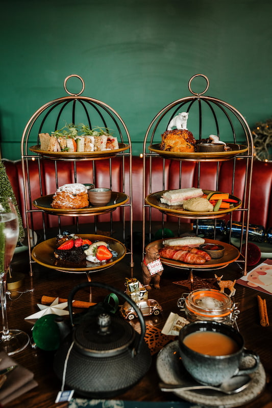 Two Festive Afternoon Teas on a decorated table at The Maynard, Grindleford